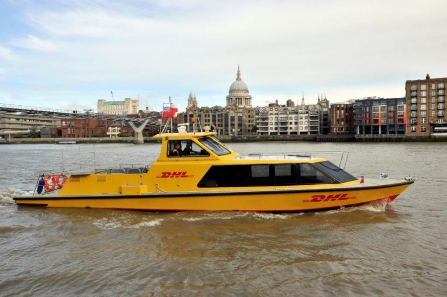 DHL Express riverboat on river with St Pauls
