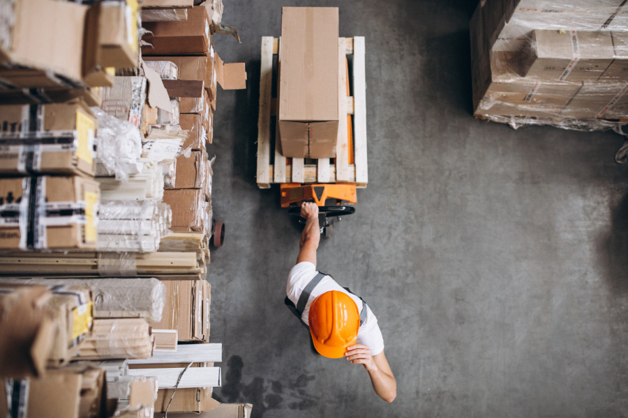 Young man working at warehouse with boxes